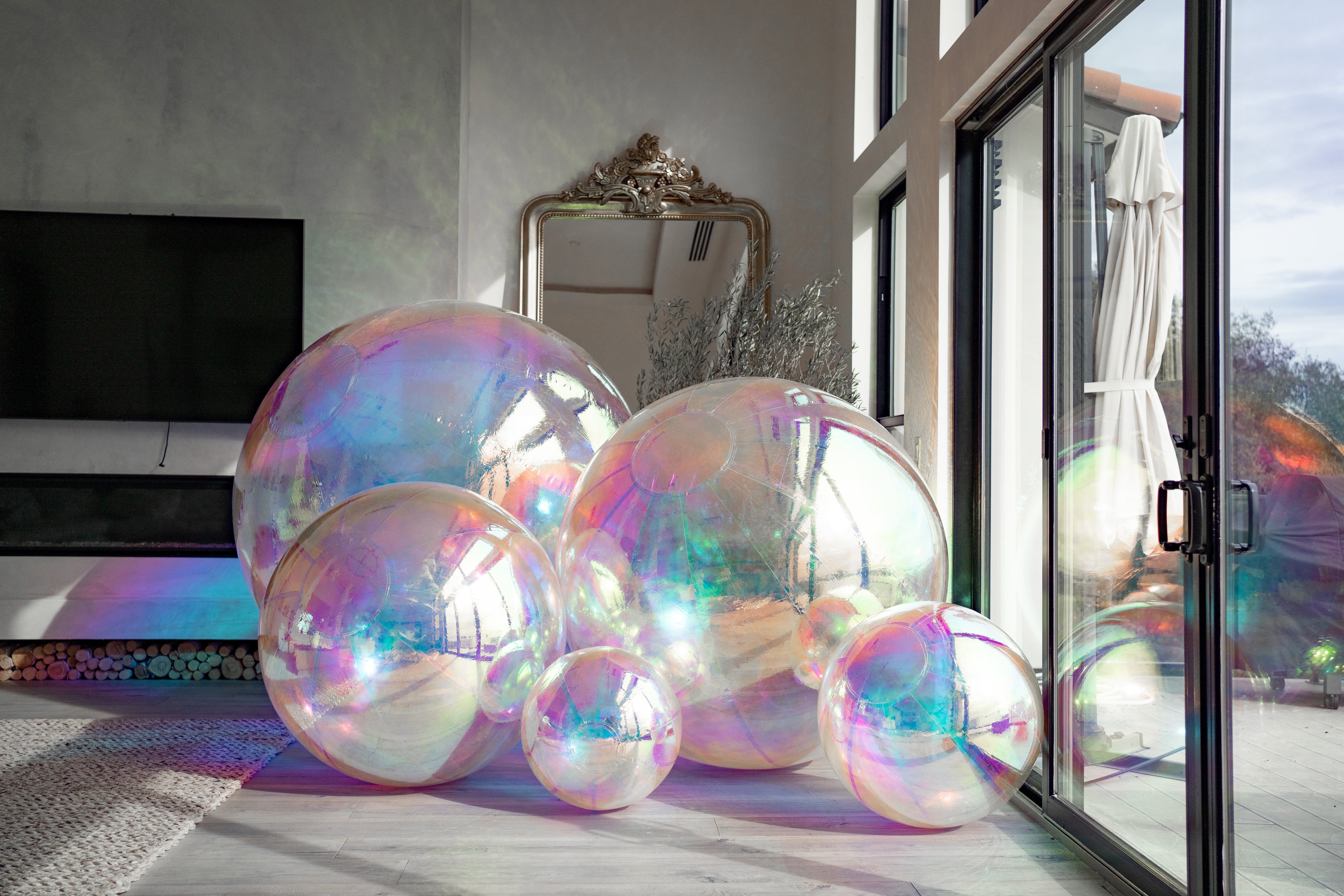 himmering iridescent large balls with a reflective, colorful surface, creating a magical and eye-catching play atmosphere.